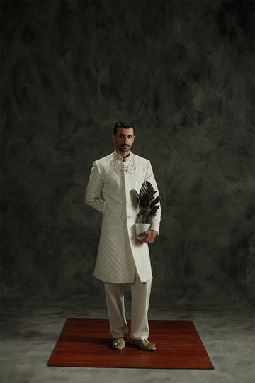 Ivory white wedding sherwani for men with intricate design details